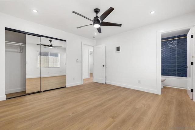 unfurnished bedroom featuring ceiling fan, light hardwood / wood-style floors, and a closet