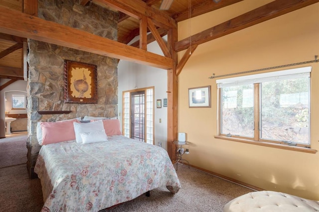 carpeted bedroom with lofted ceiling with beams and baseboards