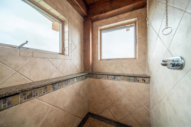 bathroom featuring plenty of natural light and a tile shower