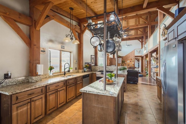 kitchen with wooden ceiling, stainless steel appliances, a sink, brown cabinetry, and beamed ceiling