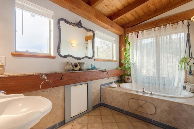 full bathroom with lofted ceiling with beams, wooden ceiling, a garden tub, a sink, and tile patterned floors