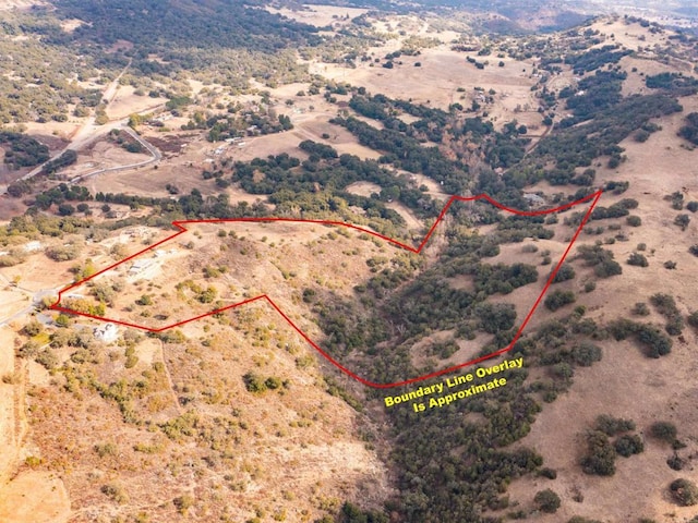 birds eye view of property featuring a desert view and a rural view