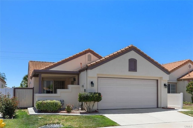 mediterranean / spanish-style house with a garage