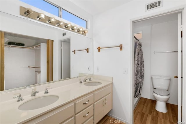 bathroom with vanity, toilet, hardwood / wood-style floors, and curtained shower