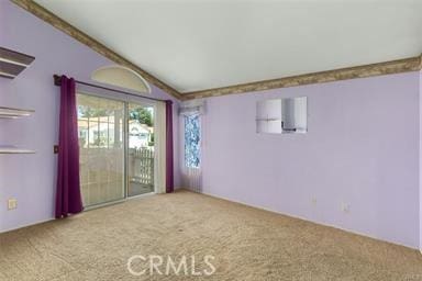 carpeted empty room with lofted ceiling