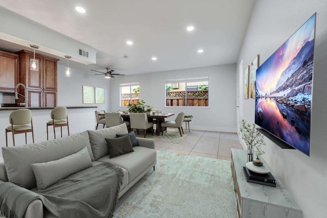 tiled living room with ceiling fan