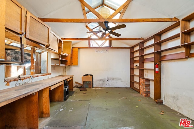 kitchen featuring ceiling fan and lofted ceiling