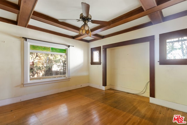 unfurnished bedroom with coffered ceiling, hardwood / wood-style floors, beam ceiling, and ceiling fan