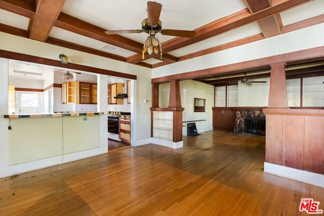 unfurnished living room featuring a fireplace, dark hardwood / wood-style floors, ceiling fan, and beam ceiling