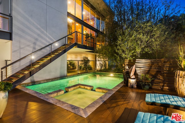 view of pool with an in ground hot tub