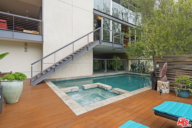 view of pool with an in ground hot tub