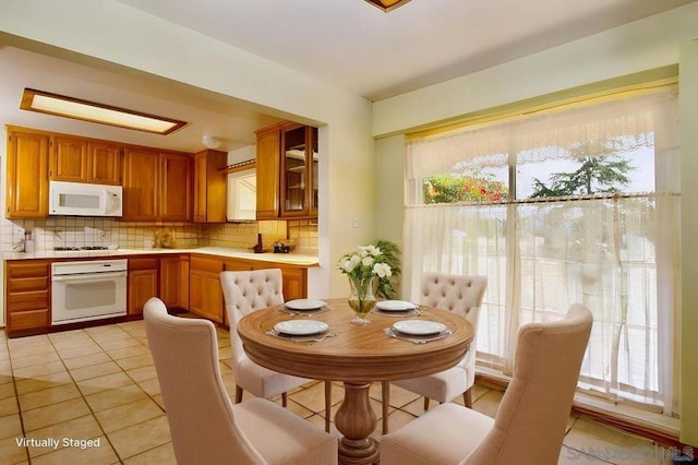 dining space featuring plenty of natural light and light tile patterned flooring