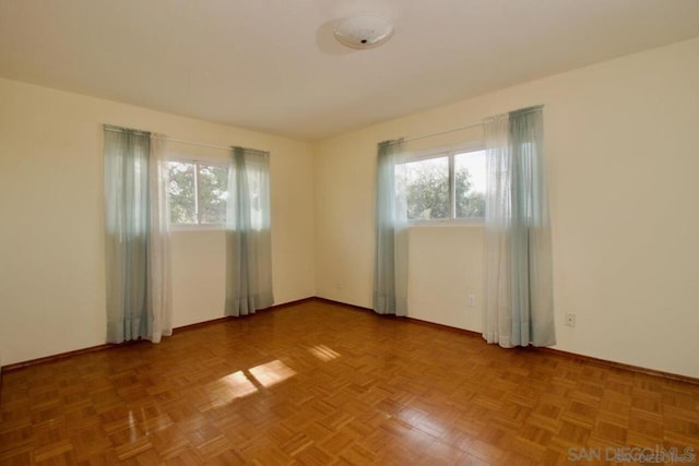 unfurnished room featuring parquet floors