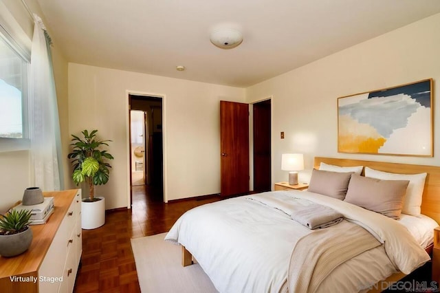 bedroom featuring multiple windows and dark parquet flooring