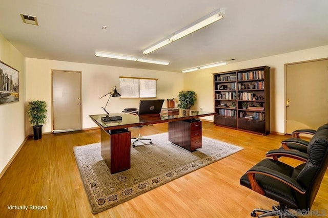 home office with hardwood / wood-style floors