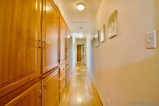 corridor with light hardwood / wood-style floors