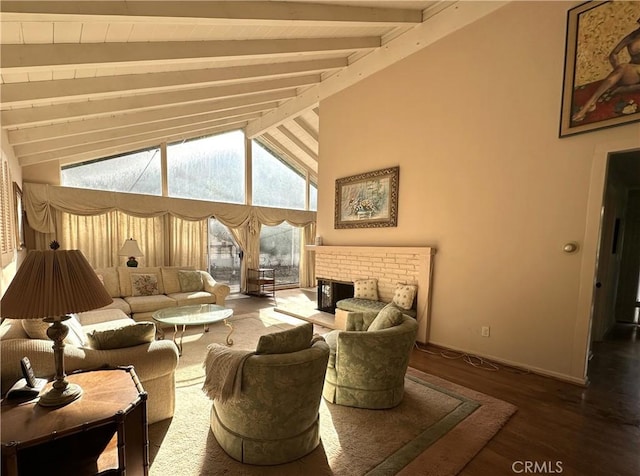 living room featuring a fireplace, hardwood / wood-style floors, and vaulted ceiling with beams