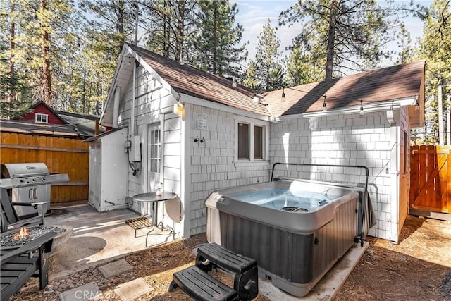 view of patio / terrace with a hot tub and a grill