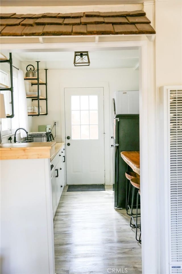 doorway to outside with light wood-type flooring