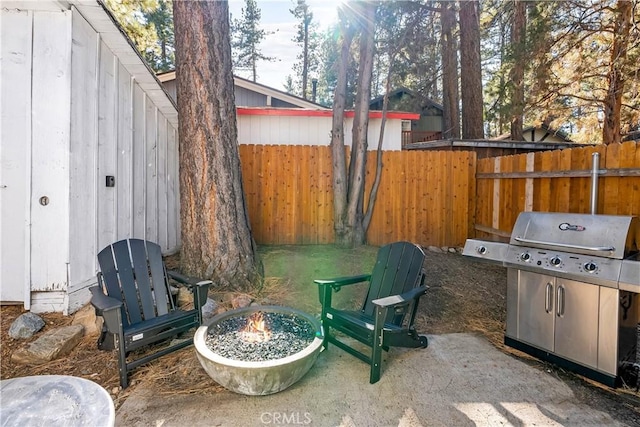 view of patio / terrace featuring an outdoor fire pit and a grill