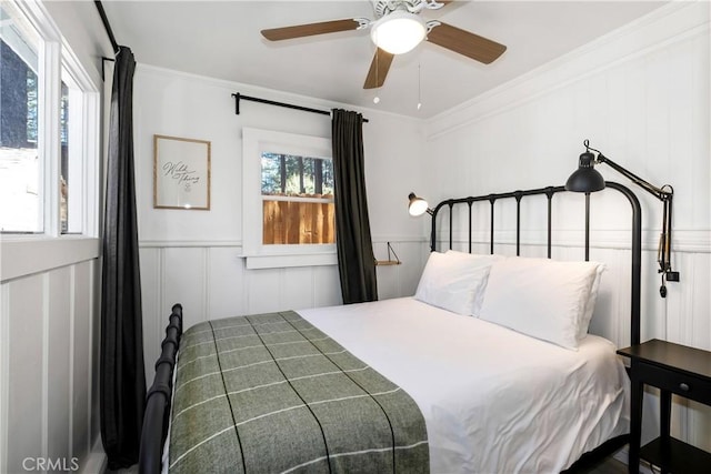 bedroom with ceiling fan and crown molding