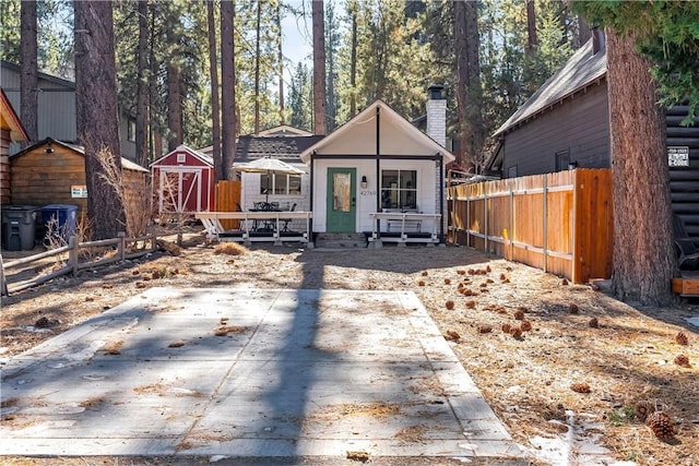 view of front of home with a shed