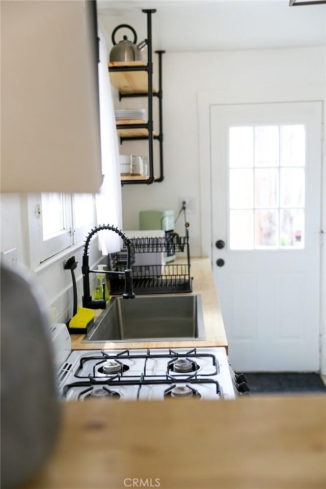 kitchen featuring sink and white gas stovetop