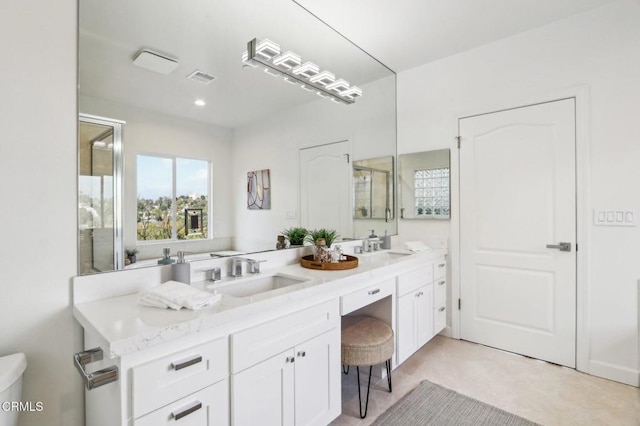 bathroom with vanity and a shower with shower door