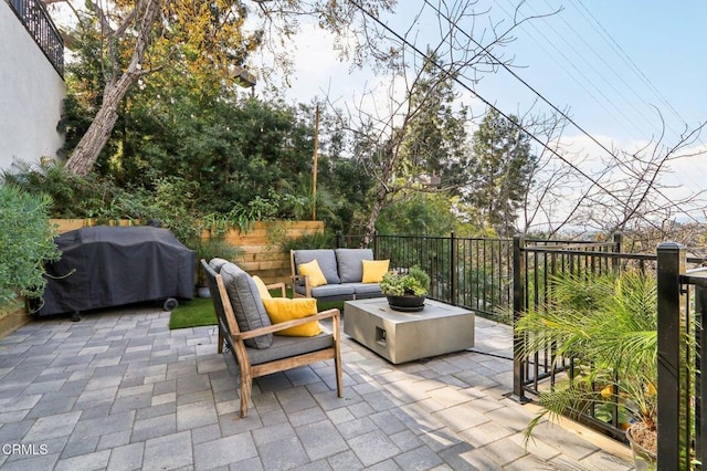 view of patio / terrace with an outdoor living space and a grill