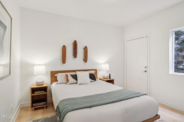 bedroom with baseboards and light wood-type flooring