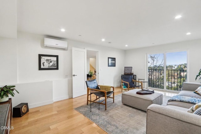 living room featuring light wood-style flooring, baseboards, a wall mounted air conditioner, and recessed lighting