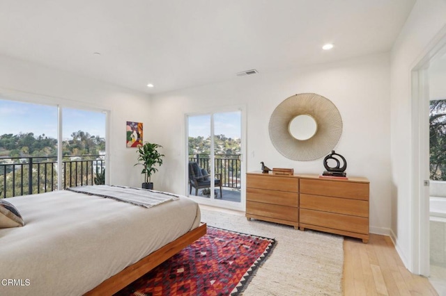 bedroom with visible vents, light wood-style floors, recessed lighting, and access to outside