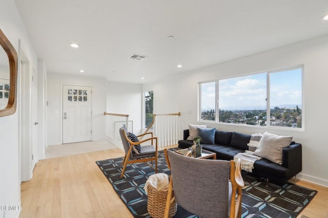 living room with visible vents, recessed lighting, and light wood-type flooring