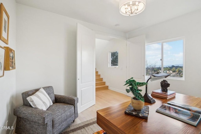 office area featuring an inviting chandelier and light wood-style flooring