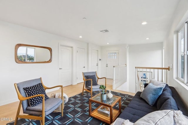 living room with wood finished floors, recessed lighting, baseboards, and visible vents
