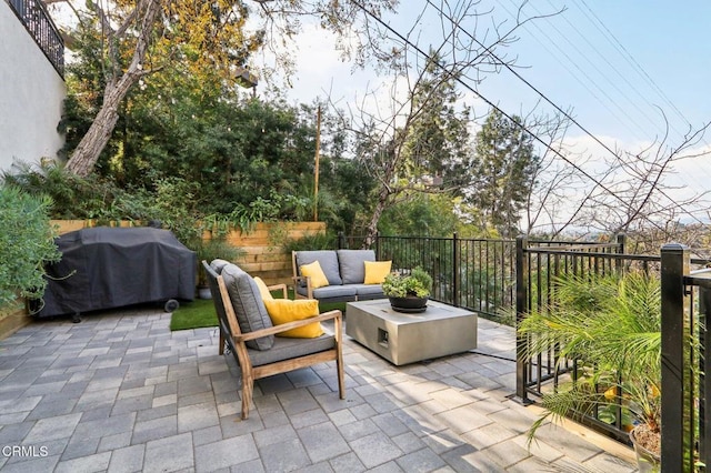 view of patio / terrace featuring fence, an outdoor living space, and a grill
