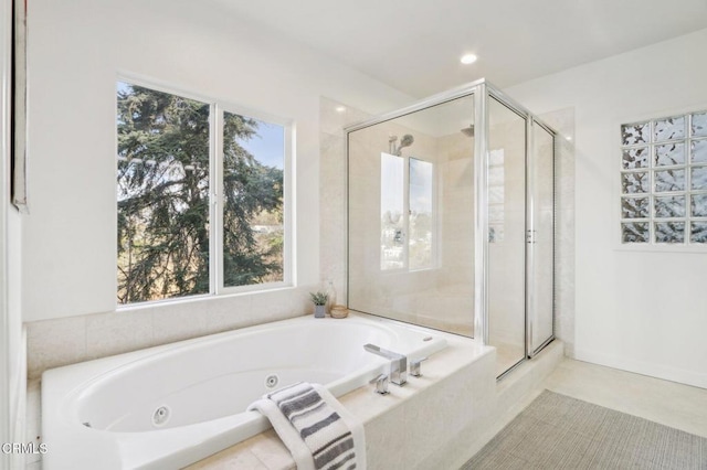 bathroom with recessed lighting, a jetted tub, and a shower stall