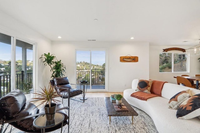living area with visible vents, recessed lighting, and wood finished floors