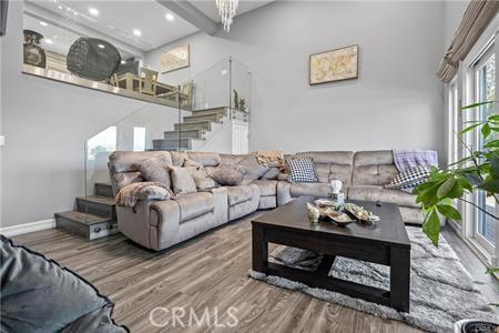 living room with hardwood / wood-style flooring and beamed ceiling