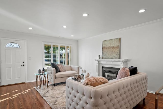 living room with dark hardwood / wood-style flooring and ornamental molding