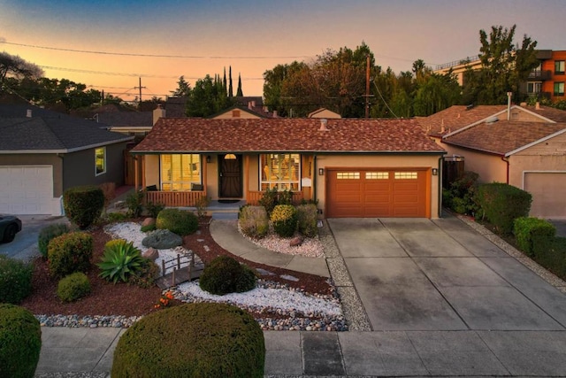 single story home with a garage and a porch