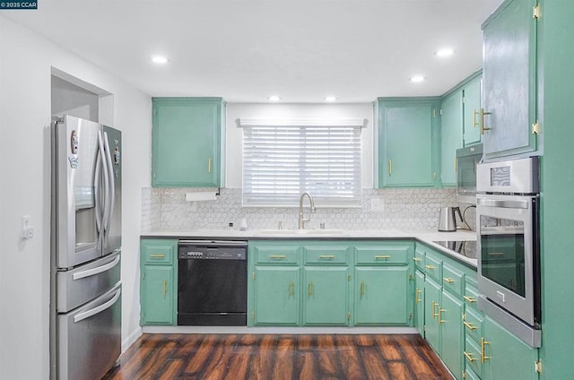 kitchen featuring sink, dark wood-type flooring, black appliances, and green cabinets