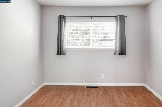 empty room with light hardwood / wood-style flooring