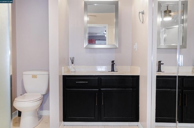 bathroom featuring vanity, walk in shower, and toilet