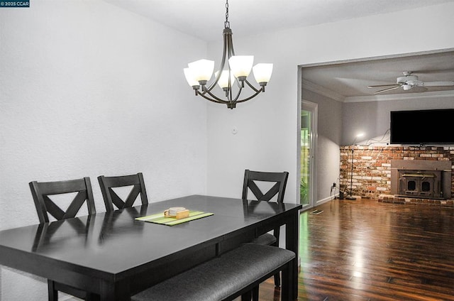 dining space with hardwood / wood-style flooring, ornamental molding, and ceiling fan with notable chandelier