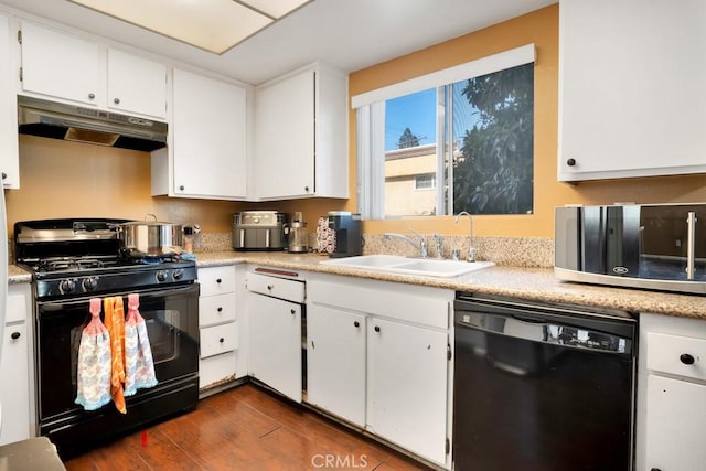 kitchen featuring dark wood-type flooring, white cabinets, black appliances, and sink