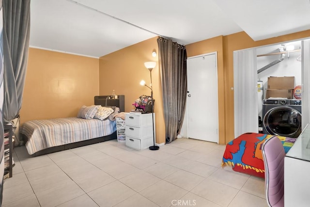 bedroom featuring washer / clothes dryer and light tile patterned flooring