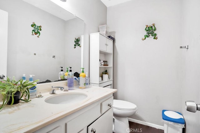 bathroom featuring hardwood / wood-style flooring, toilet, and vanity