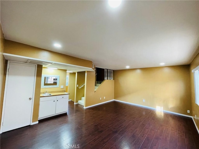 interior space featuring stairway, baseboards, dark wood-style flooring, and recessed lighting