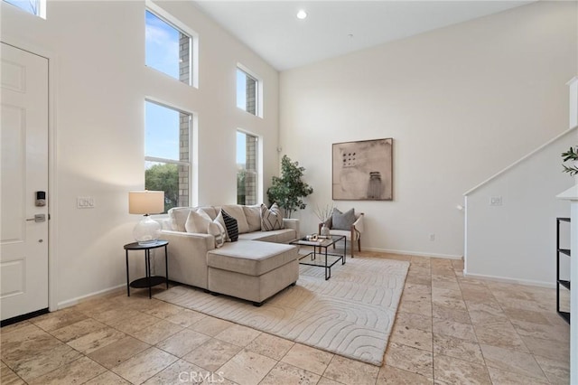 living room featuring a towering ceiling